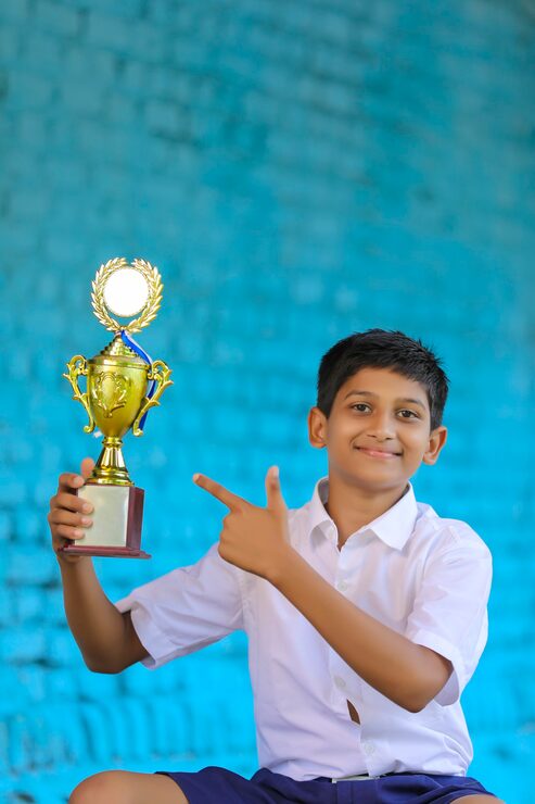 Smiling student writing beside an open book